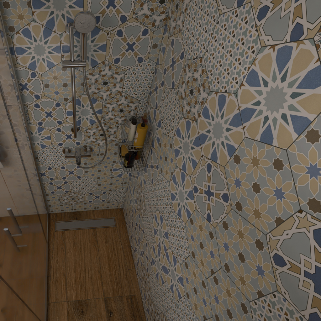 Shower alcove with blue, beige, and gray patterned tile walls, a handheld showerhead, and a metal caddy holding shampoo bottles.