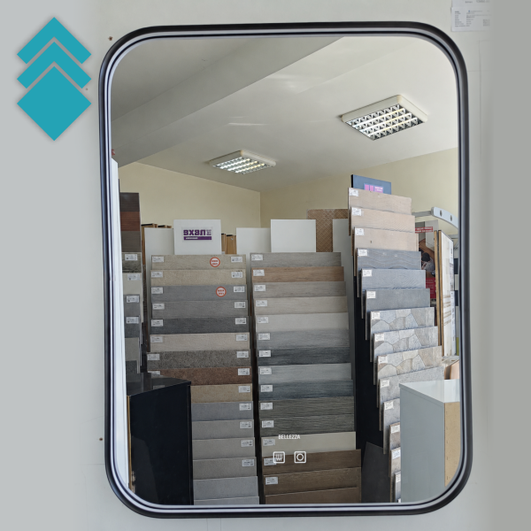 Interior of a tile showroom with tall stacked color sample boards and ceiling lights above.