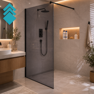 Modern bathroom featuring a black-framed glass shower door, gray tiled walls, and a built-in niche with shampoo bottles and soap.